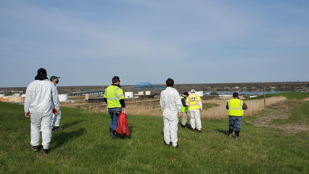 U.S. Army Corps team surveying the grassy Seaway FUSRAP landfill site in Tonawanda
